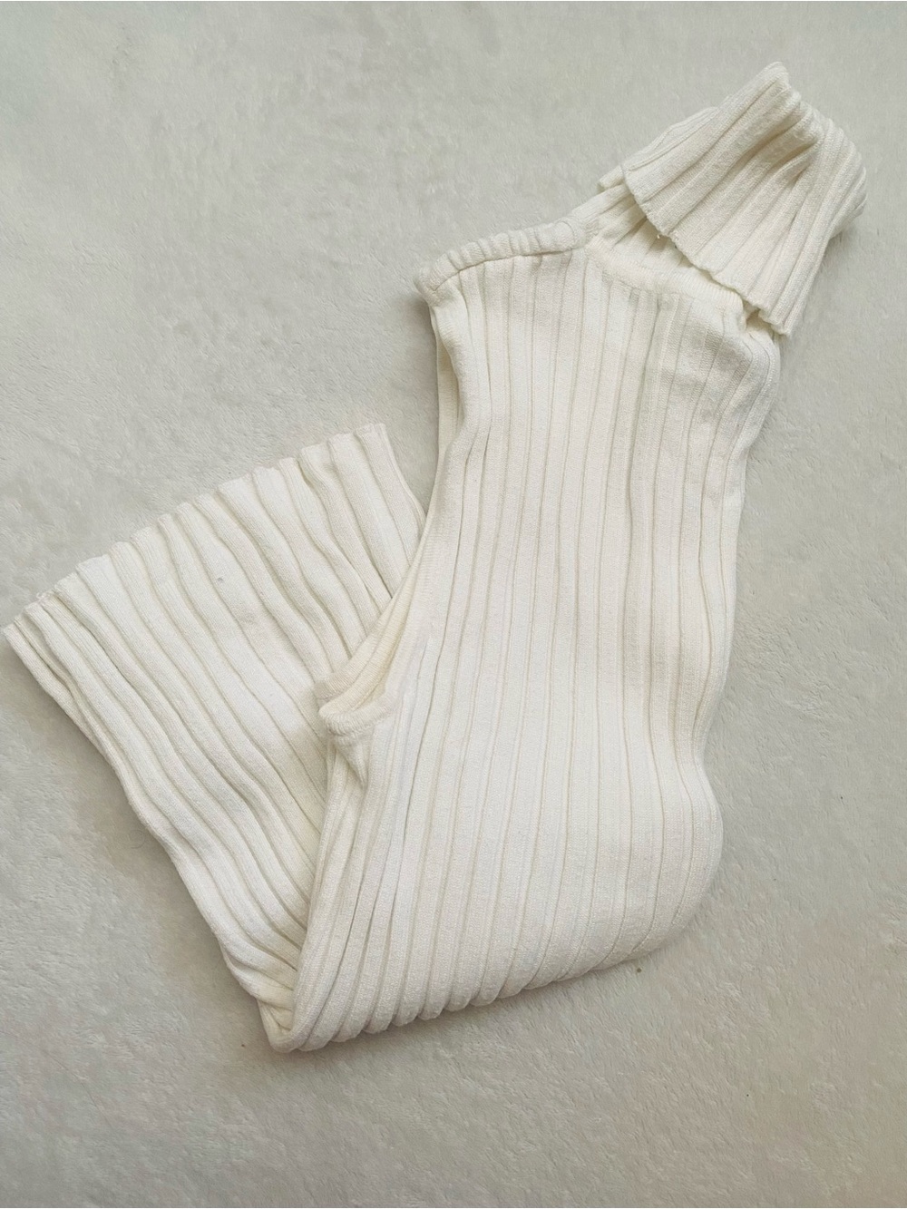 sleeveless turtleneck blouse in Cream